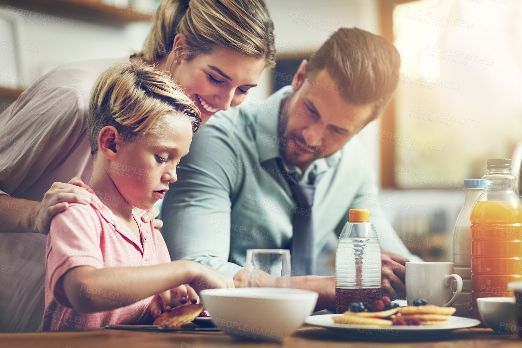 Buy stock photo Home, parents and boy with breakfast, smile and happiness in kitchen, bonding together and nutrition. Family, mother and father with kid, healthy food or meal with pancakes, wellness or help in house