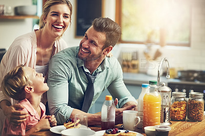 Buy stock photo Cropped shot of a little boy eating breakfast with his parents