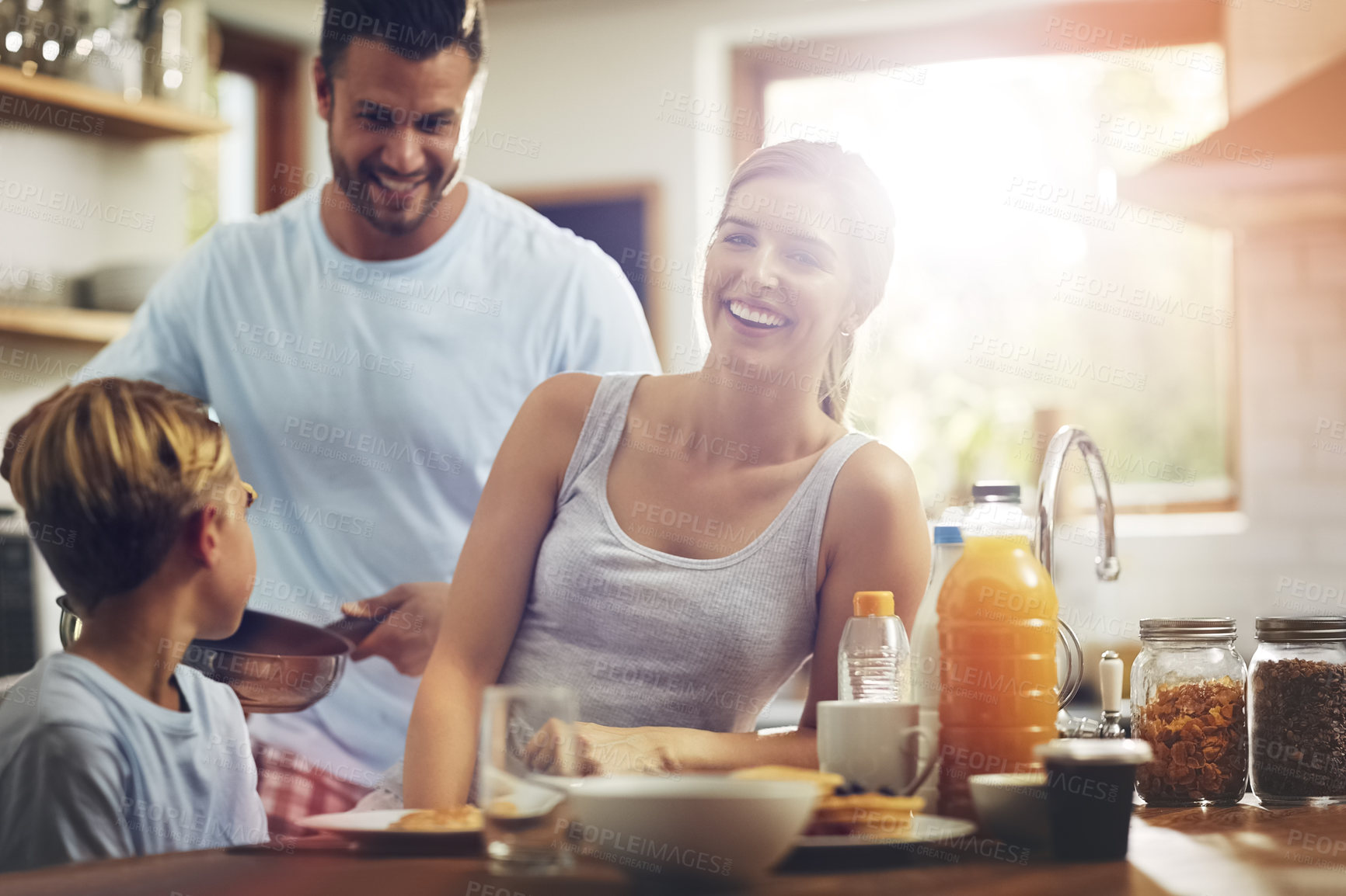 Buy stock photo Happy family, breakfast and portrait in kitchen for nutrition, mother and healthy meal in morning. Parents, kid and smile at table for pancakes, brunch or wellness while together at home for bonding