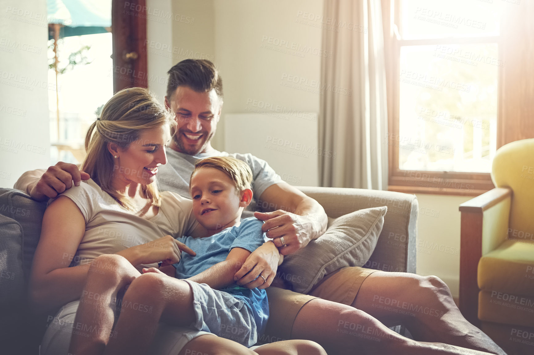 Buy stock photo Shot of a family of three spending some quality time at home