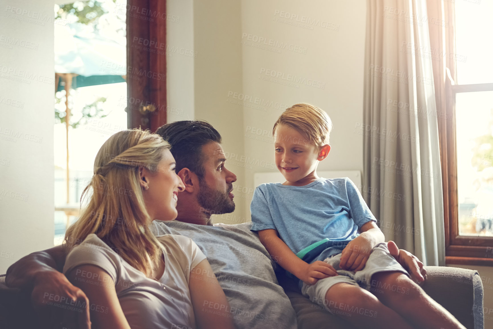 Buy stock photo Shot of a family of three spending some quality time at home