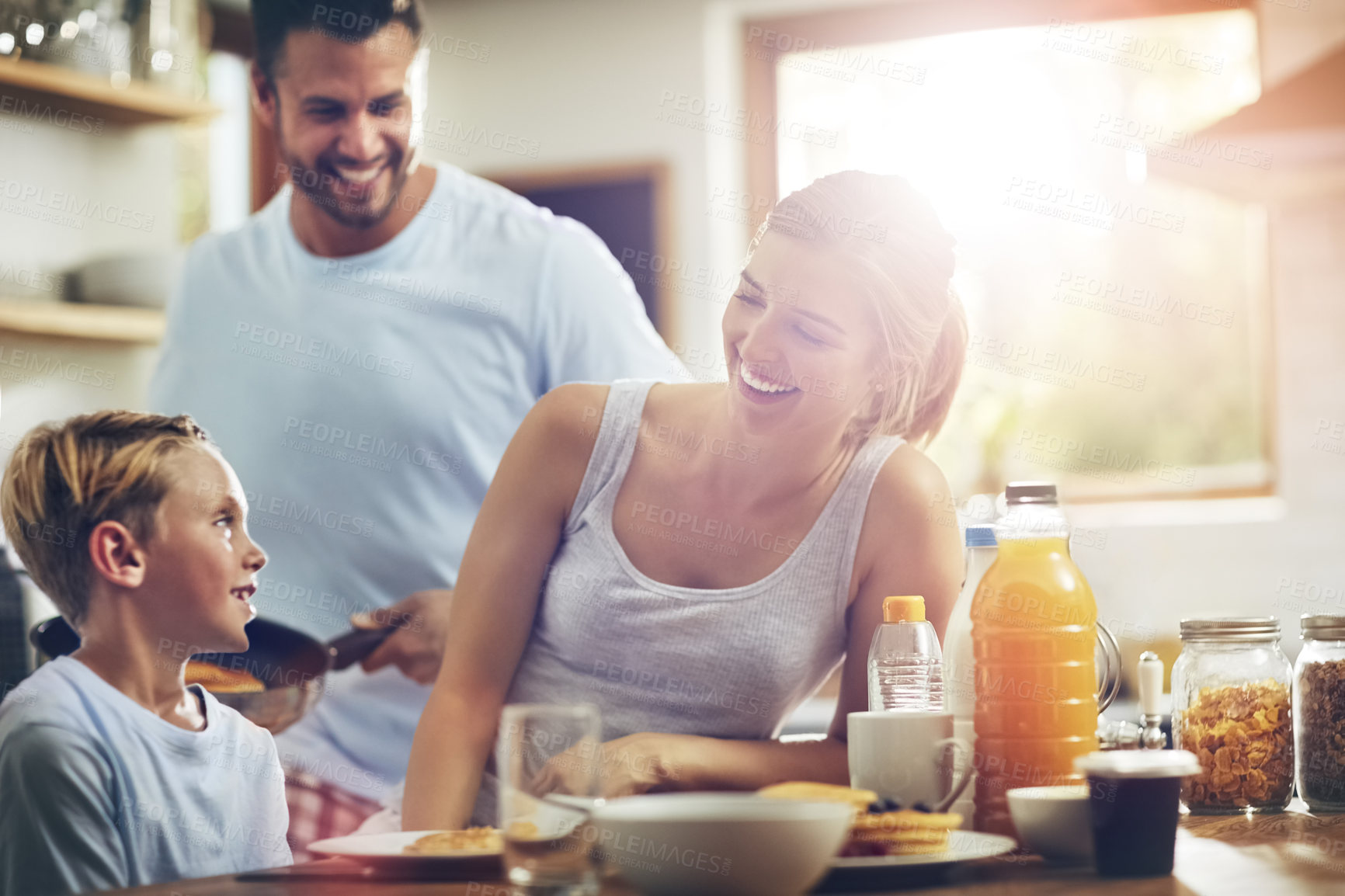 Buy stock photo Happy family, love and breakfast in kitchen for nutrition, support and healthy meal in morning. Parents, kid and smile at table for gathering, brunch and wellness while together at home for bonding