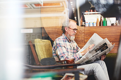 Buy stock photo Newspaper, research and senior man reading business information for financial stock market. Window, cafe and elderly male person enjoying economy headlines in journalism article in coffee shop.