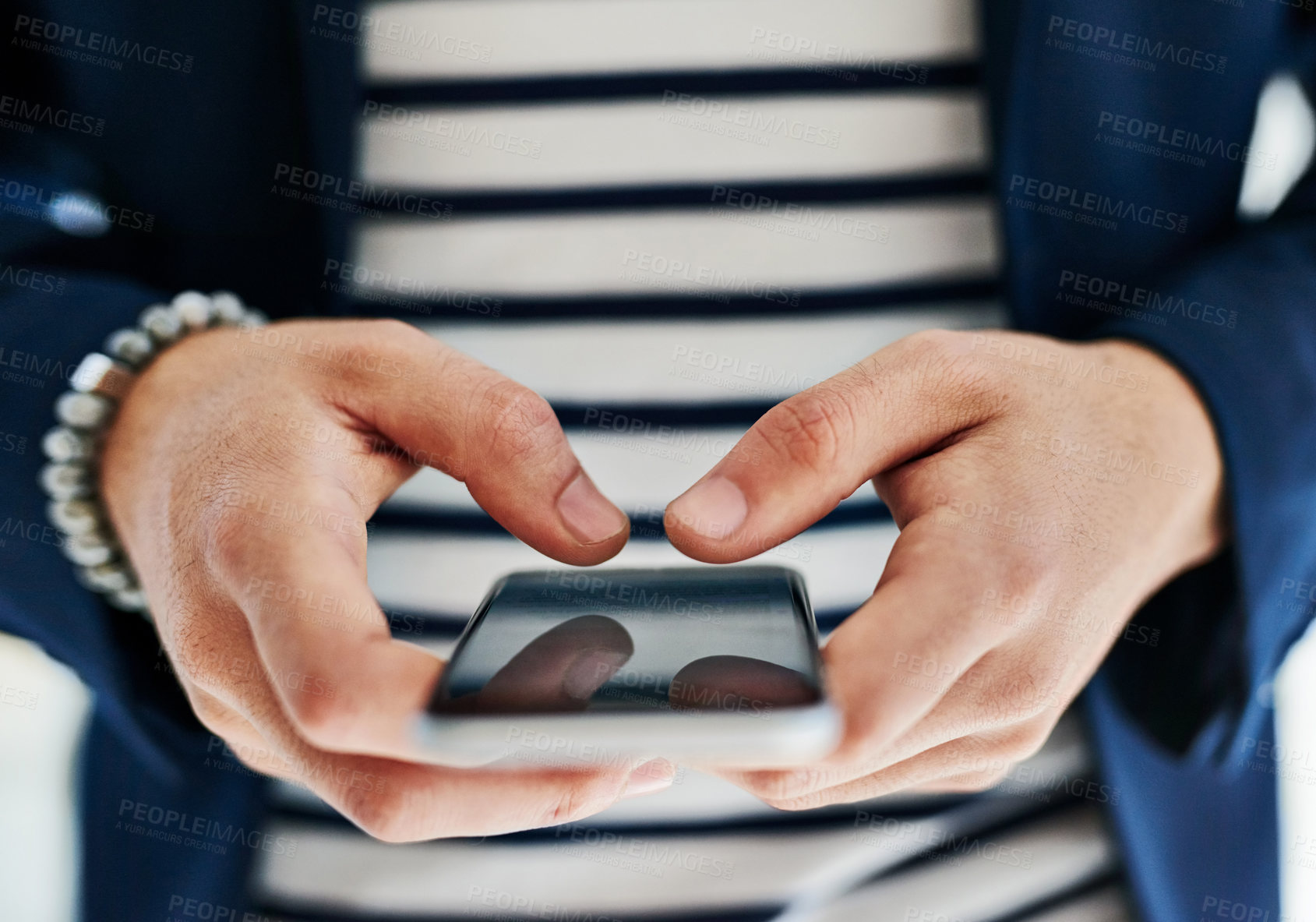 Buy stock photo Cropped shot of a businessman using a mobile phone