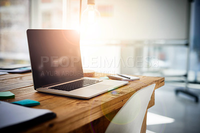 Buy stock photo Shot of a laptop on a desk in a modern office 