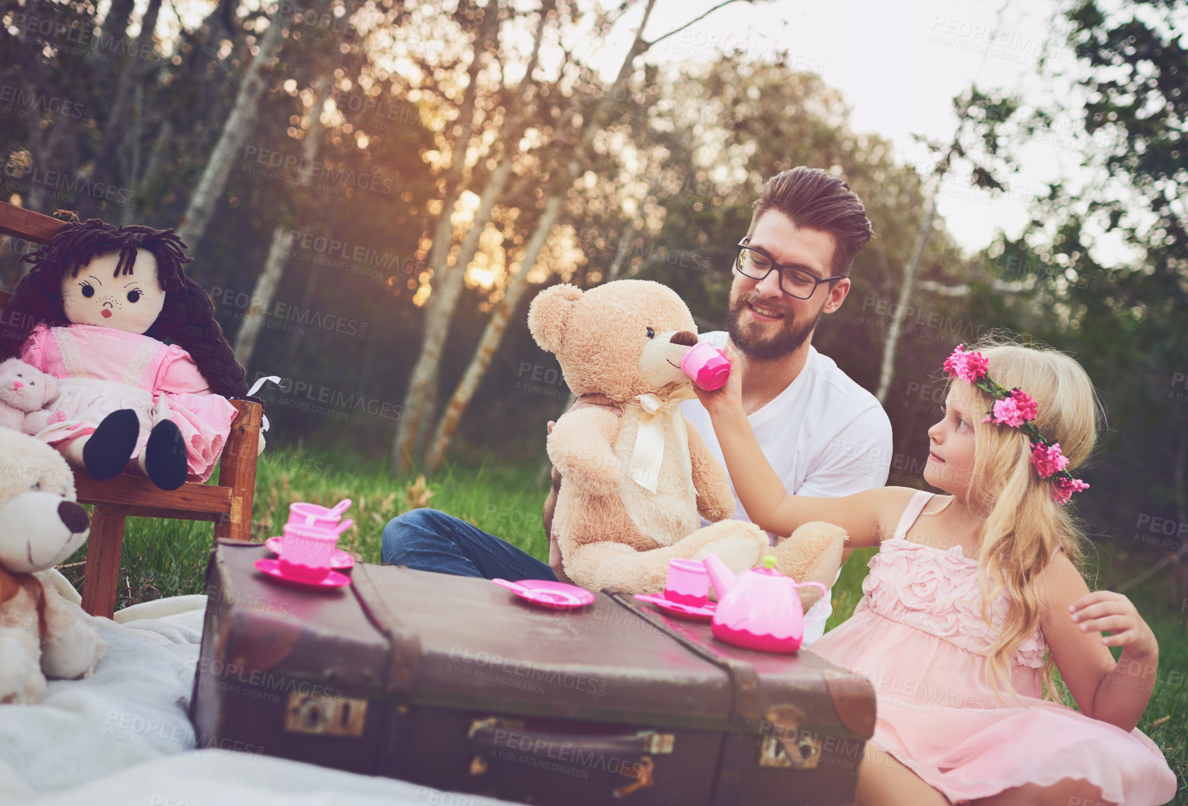 Buy stock photo Dad, tea party and girl kid in garden for nature picnic with toys, teddy bear drink and suitcase for table. Daughter, father and memory together for playing or fun, bonding and love in outdoor.