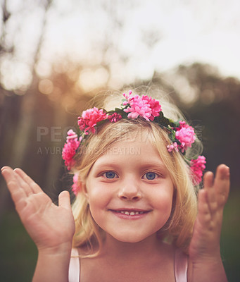 Buy stock photo Shot of a happy little girl smiling and looking at the camera after she opened her eyes playing hide and seek outside in nature