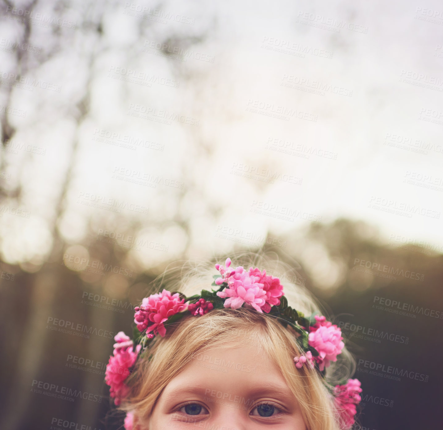 Buy stock photo Shot of a little girl's eyes looking at the camera and hiding while standing outside in nature