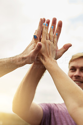 Buy stock photo Shot of a group young friends engaging in a high five outside next to a road