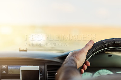 Buy stock photo Shot of a unrecognizable man driving in a vehicle with his cellphone   attached to the dashboard