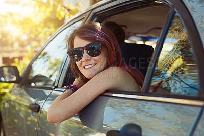 Buy stock photo Shot of a young woman taking a break and looking at the camera while sitting in the backseat of a car
