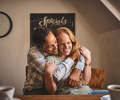 Buy stock photo Happy couple, hug and smile in date at cafe for romance, embrace or relationship happiness indoors. Young man hugging woman and smiling for fun love or dining spending bonding time at restaurant