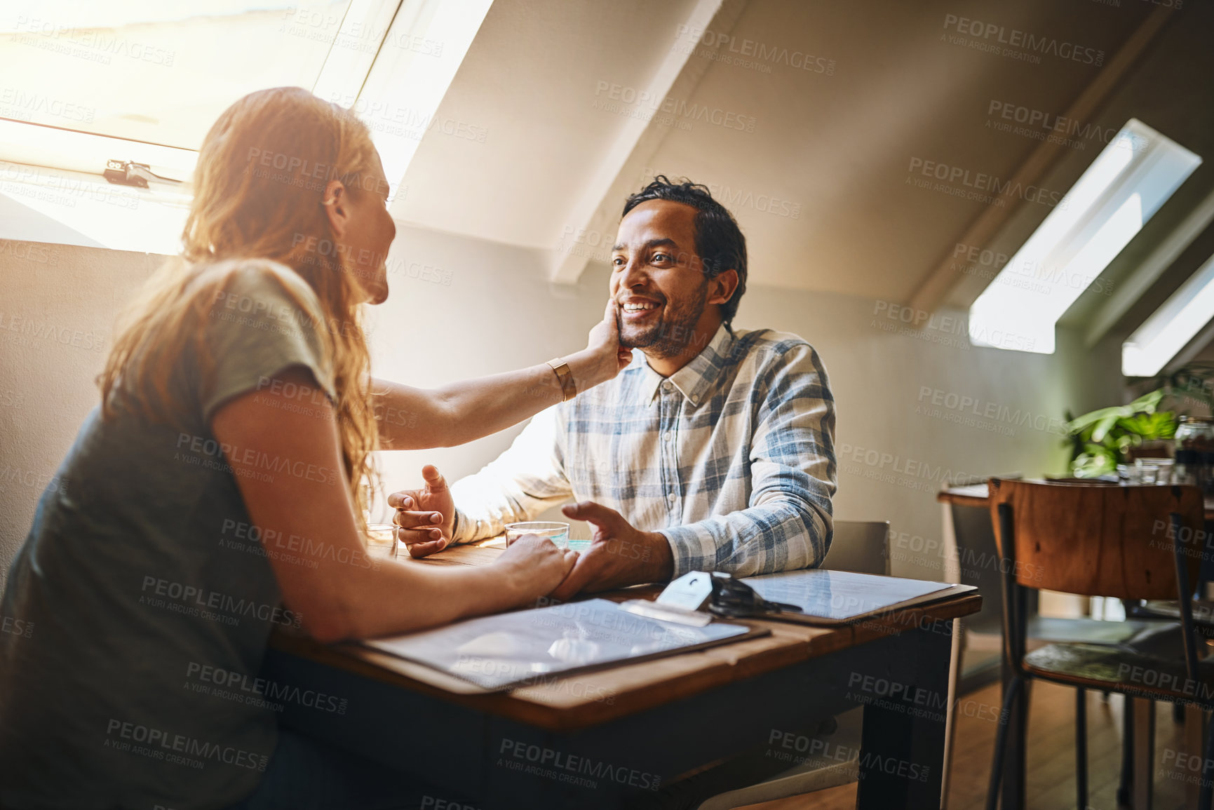 Buy stock photo Support, love and couple holding hand for empathy, reconciliation or bonding in a coffee shop. Care, sympathy and young woman supporting and touching her husband while having a conversation in a cafe