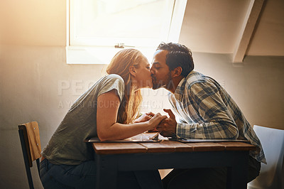 Buy stock photo Couple, love kiss and holding hands at restaurant, intimacy or bonding together at table. Valentines day, romance diversity and affection, kissing and care of man and woman enjoying date time at cafe