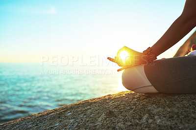 Buy stock photo Cropped shot of a woman practising the lotus pose on the beach
