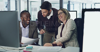 Buy stock photo Cropped shot of three businesspeople discussing some paperwork in their office