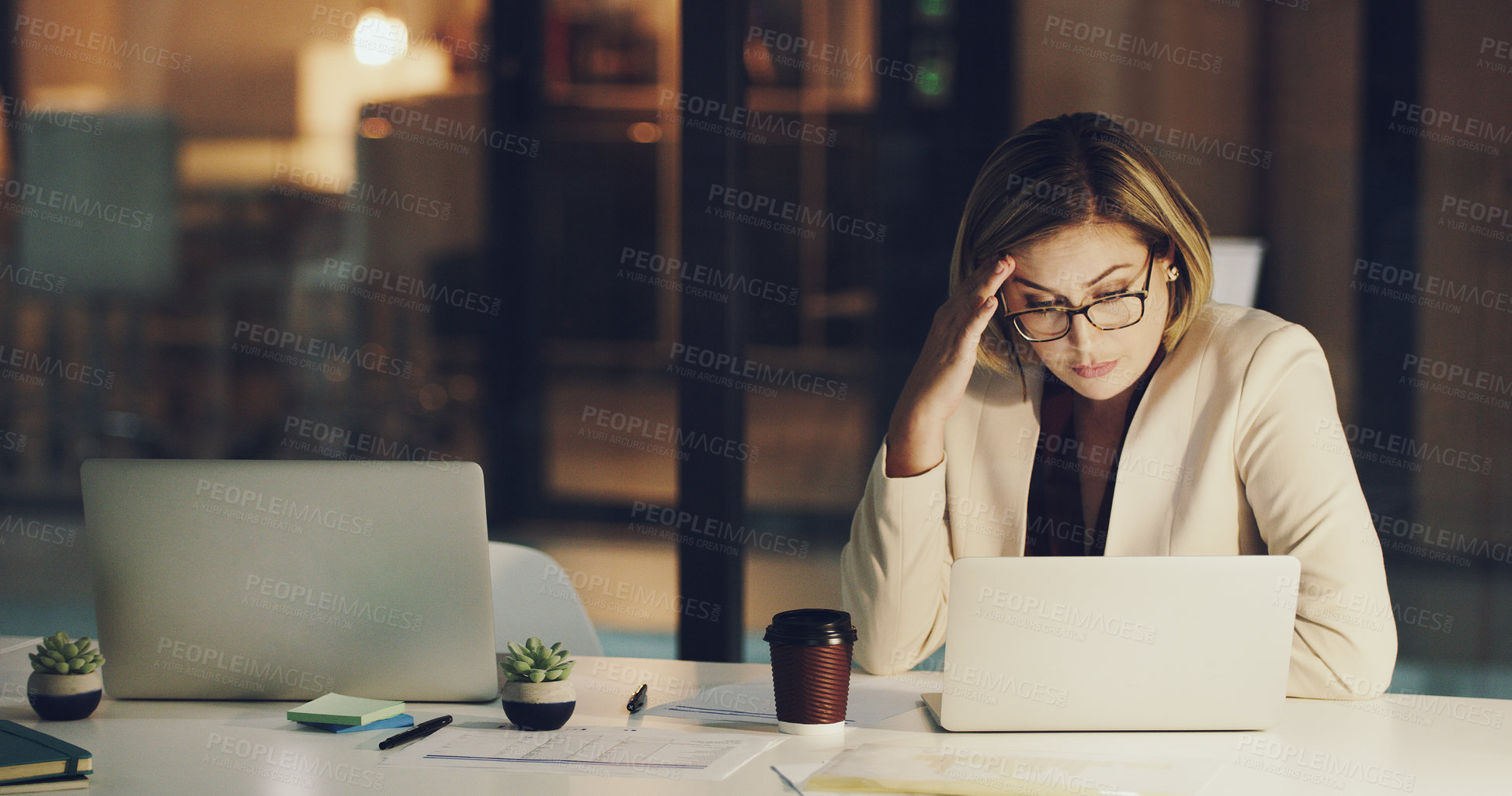 Buy stock photo Cropped shot of a businesswoman looking stressed while working in her office