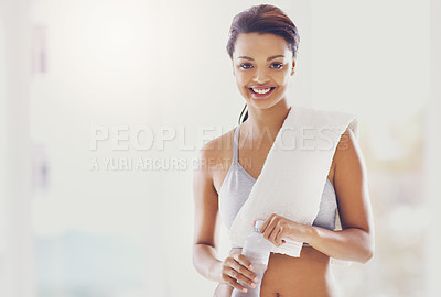 Buy stock photo Cropped portrait of an attractive young woman taking a water break during her workout at home