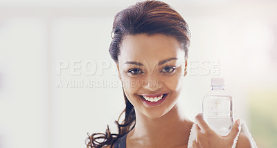 Buy stock photo Cropped portrait of an attractive young woman taking a water break during her workout at home