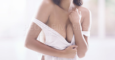 Buy stock photo Cropped shot of an unrecognizable young woman pulling on her top