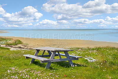 Buy stock photo Picnic table, beach and landscape with nature and travel, environment and coastal location in Denmark. Ocean view, fresh air and natural scenery with seaside destination, land and journey with meadow