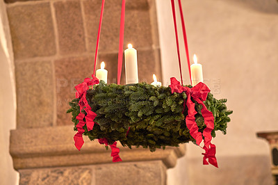 Buy stock photo Decorative ornament hanging from the roof inside a building. Beautiful candlelight wedding decor indoors. A Christmas design indoors of a church. Red and green adornment creatively beautifying a room