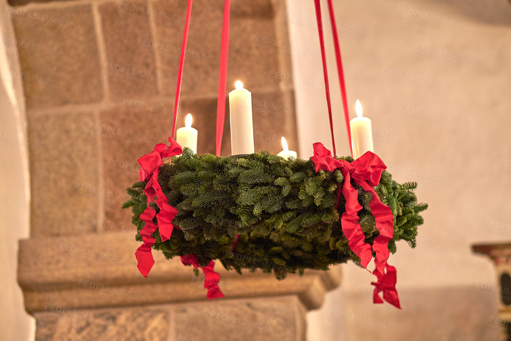 Buy stock photo Decorative ornament hanging from the roof inside a building. Beautiful candlelight wedding decor indoors. A Christmas design indoors of a church. Red and green adornment creatively beautifying a room