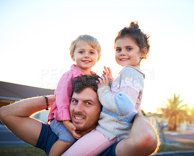 Buy stock photo Happy, portrait and father with children on shoulders for bonding, playing and having fun together. Smile, family and dad carrying girl kids for connection outdoor in backyard of home in Canada.