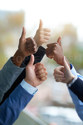 Buy stock photo Shot of a group of unrecognizable coworkers high fiving outside the office 