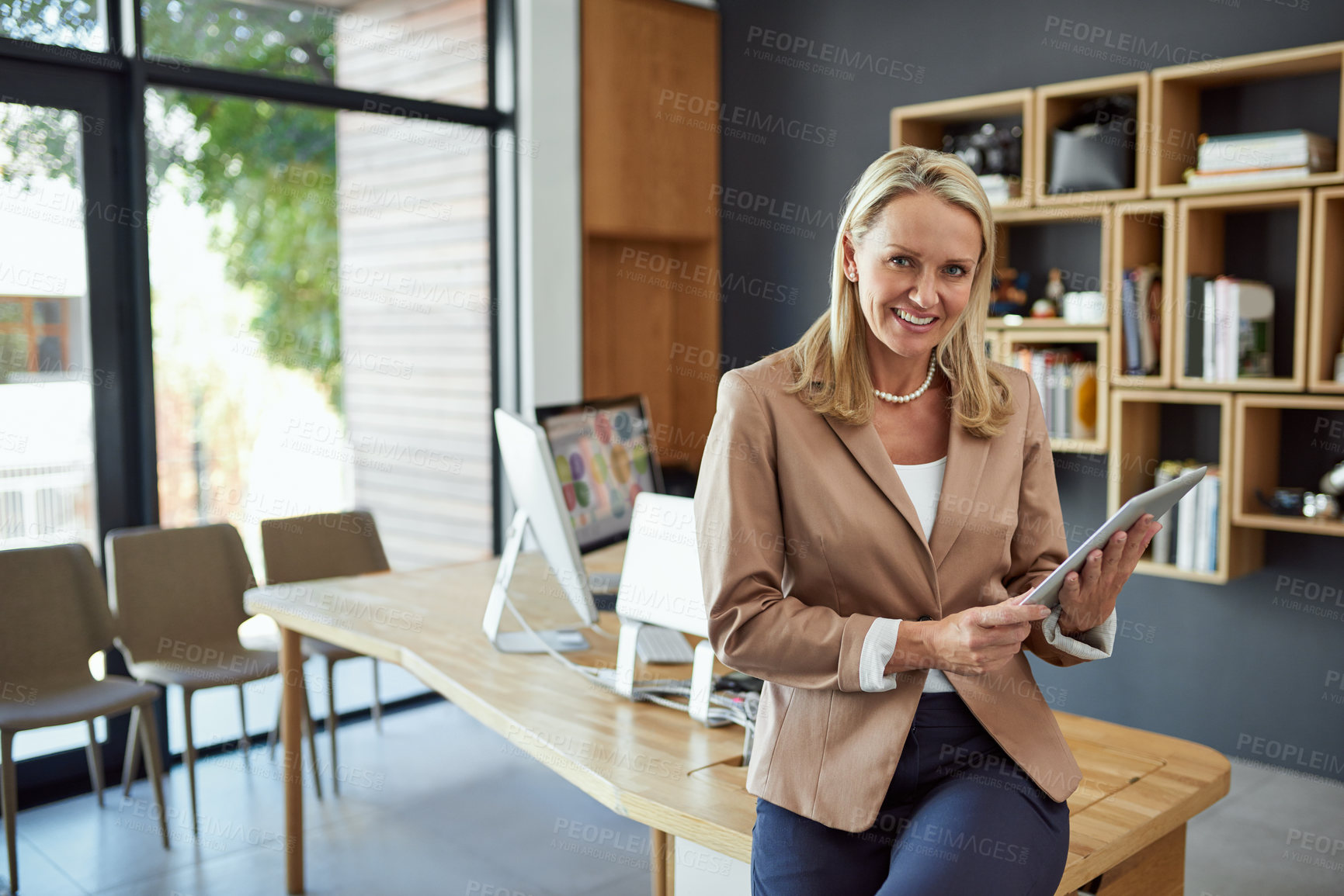 Buy stock photo Portrait of a mature businesswoman using a digital tablet in an office
