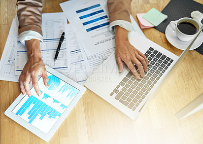 Buy stock photo Closeup shot of an unrecognisable businesswoman analysing graphs in an office