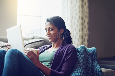 Buy stock photo Smiling, woman and tablet on sofa in home for online conversation, communication and weekend on internet. Happy, female person and technology in living room with coffee for reading, ebook or drink