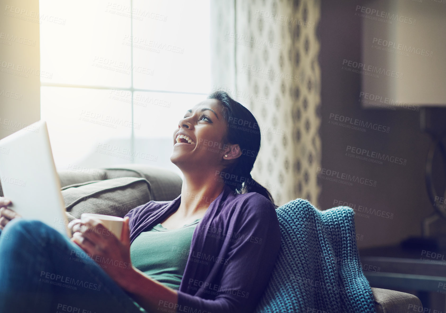 Buy stock photo Home, Indian woman and tablet on sofa to laugh, relax and comfortable with technology in living room. Apartment, happy girl and digital for streaming comedy, funny film or watch movie with coffee cup