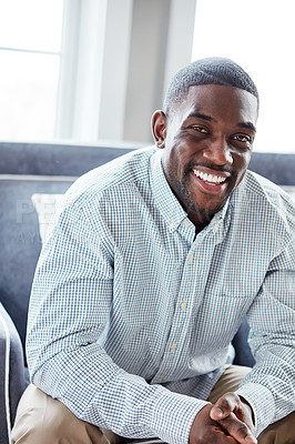 Buy stock photo Portrait of a happy young man relaxing on the sofa at home