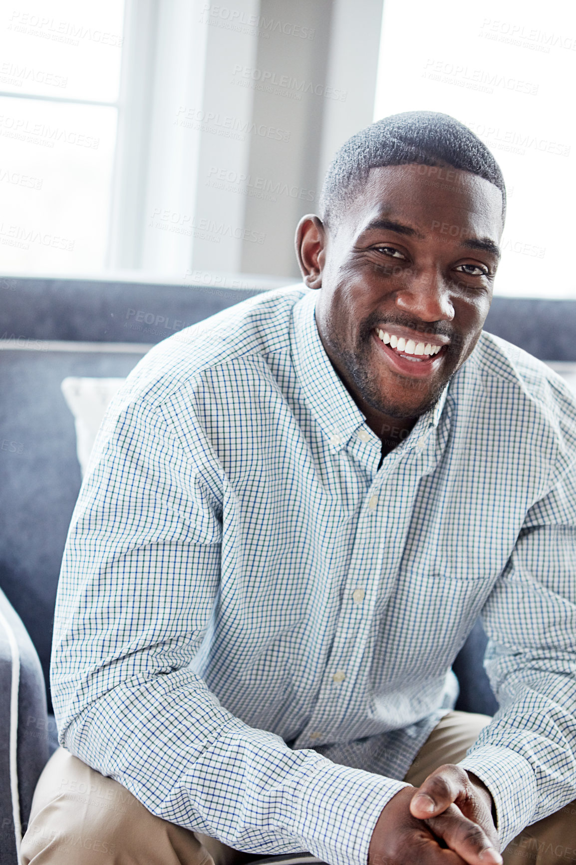 Buy stock photo Portrait of a happy young man relaxing on the sofa at home