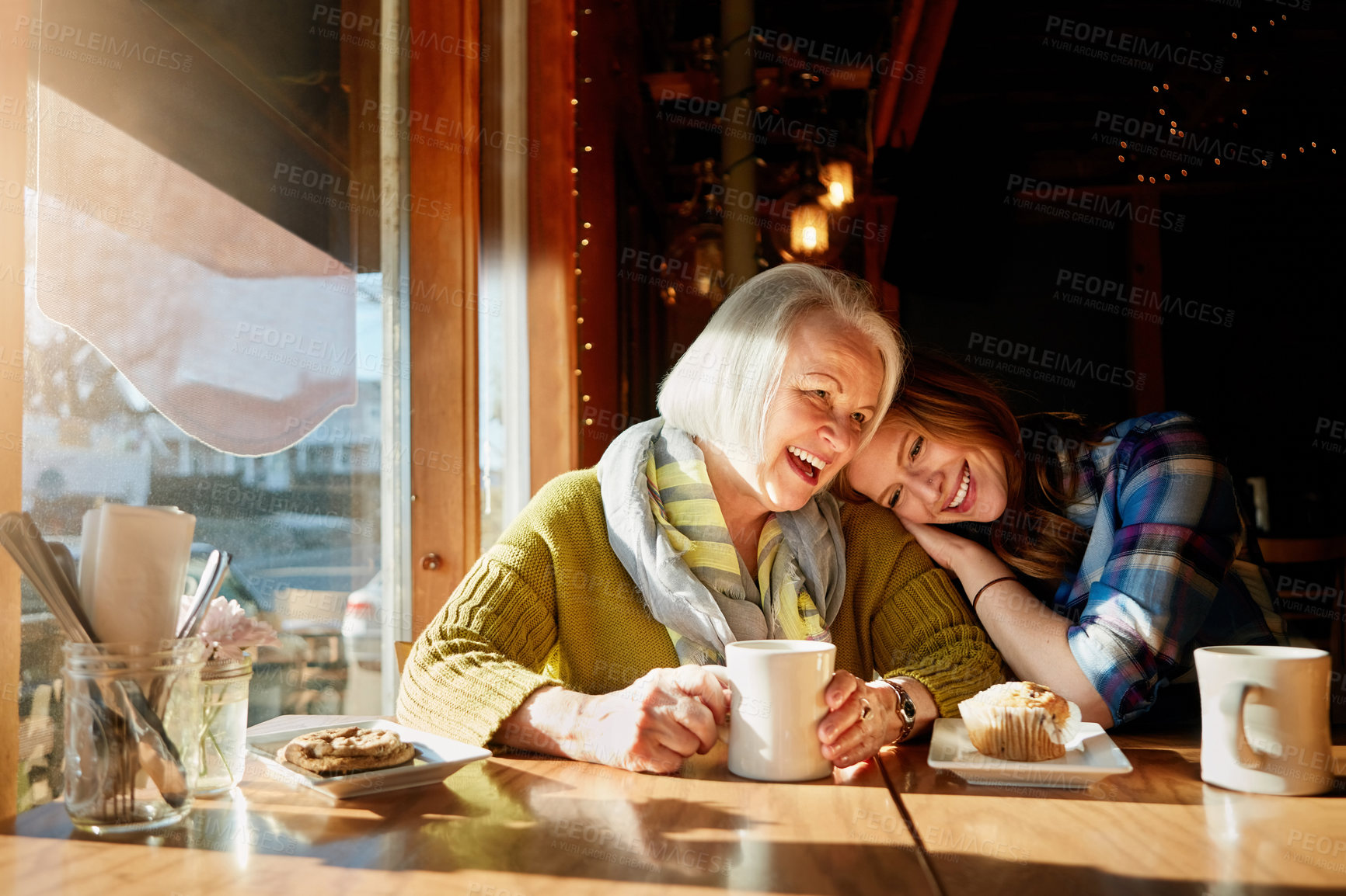 Buy stock photo Happy, daughter and senior woman with laughing in cafe for memories or bonding with hug. Restaurant, coffee shop and people with discussion, conversation and smiling family with love in Paris.