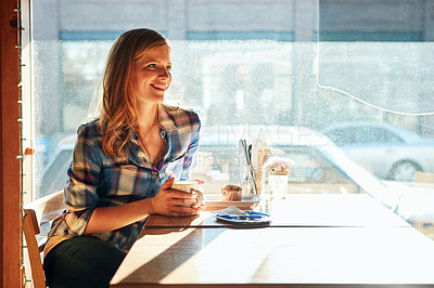 Buy stock photo Shot of an attractive young woman enjoying a cup of coffee in a cafe