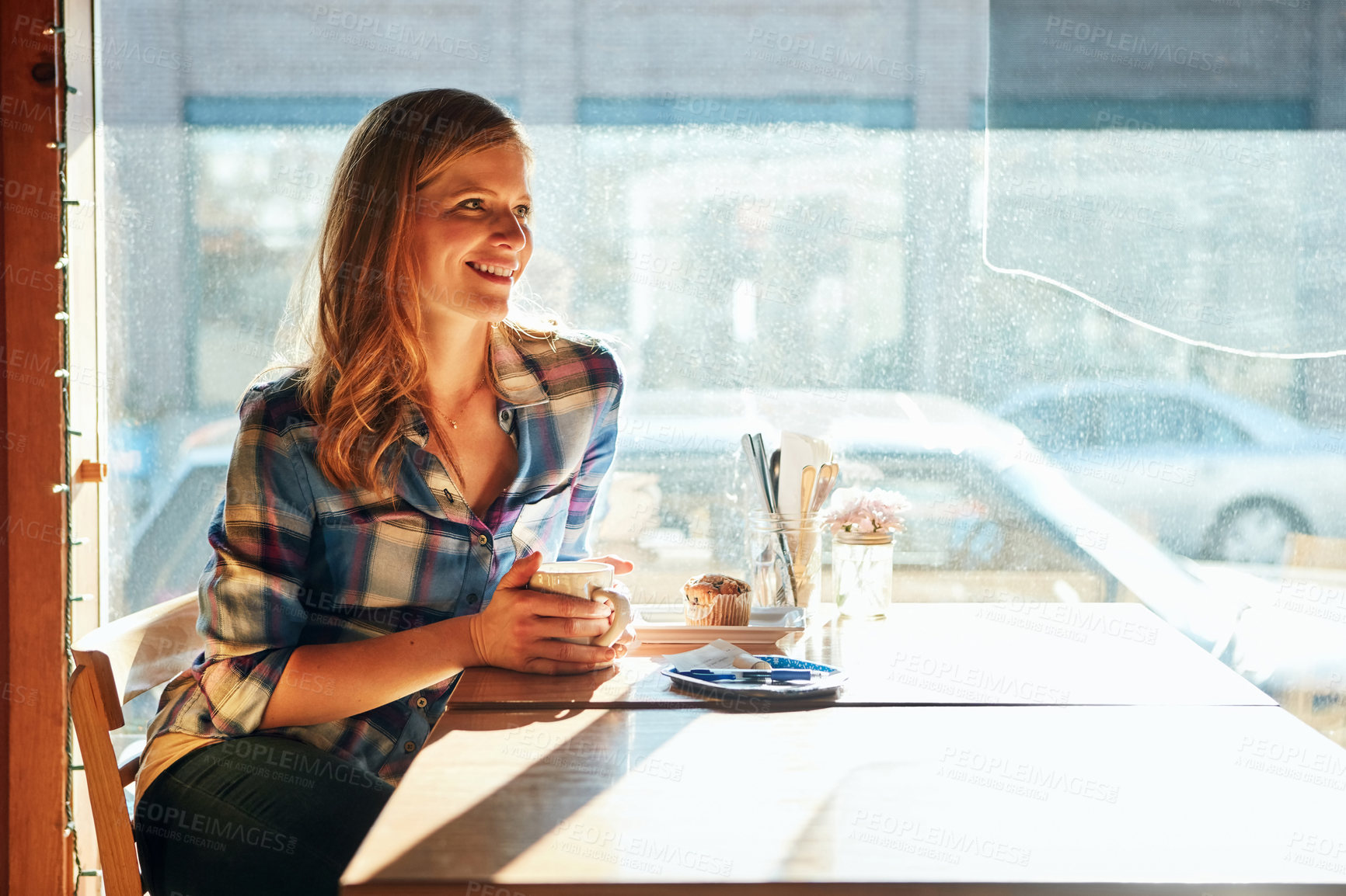 Buy stock photo Shot of an attractive young woman enjoying a cup of coffee in a cafe