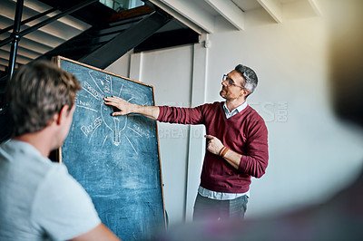 Buy stock photo Shot of a creative business team having a meeting and discussing business related issues in the office