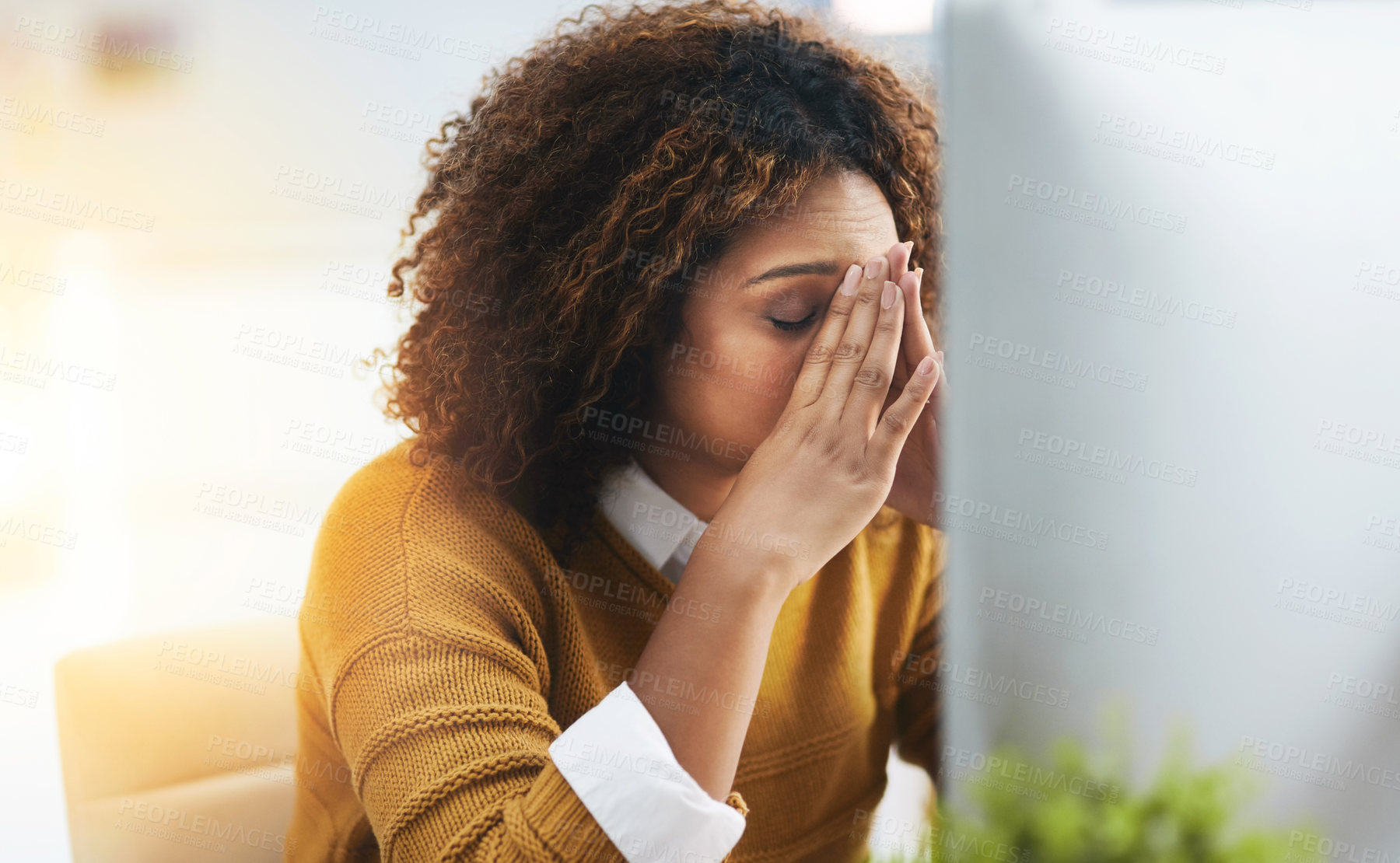 Buy stock photo Shot of a stressed young businesswoman sitting and working in the office at work