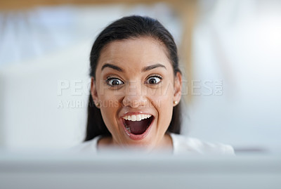 Buy stock photo Shot of a happy young businesswoman smiling and working on her computer in the office at work