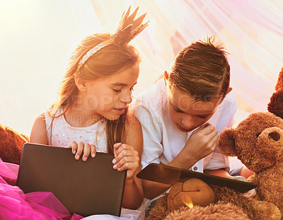 Buy stock photo Children, tablet and fort for streaming movies, playing dress up and online games for fantasy. Siblings, kids and internet for entertainment, brother and sister for watching film on subscription