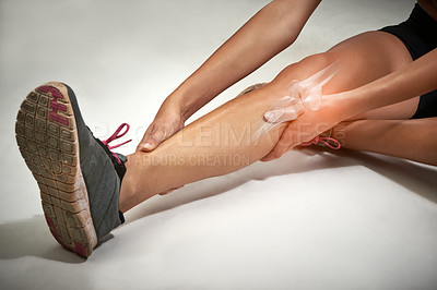 Buy stock photo Woman, knee pain and leg for injury in studio, training accident and x ray on white background. Female person, sports and joint arthritis or risk of fibromyalgia, floor bruise and emergency strain