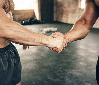 Buy stock photo Shot of two unrecognizable men greeting each other with a handshake on a good workout exercise in the gym