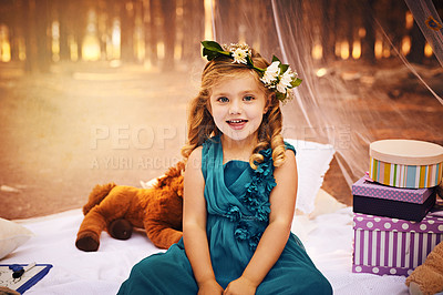 Buy stock photo Shot of a happy little girl looking at the camera while sitting on a blanket outside in the woods