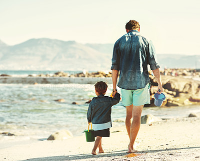 Buy stock photo Shot of an unrecognizable Father and son spending quality time at the beach