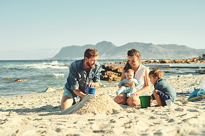 Buy stock photo Sandcastle building, parents and children at beach with bonding, love and support. Baby, mom and dad together with kids playing in the sun with mockup space and smile by the ocean and sea with family