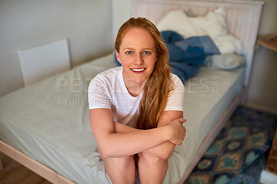 Buy stock photo Shot of a young woman sitting on her bed in the bedroom at home