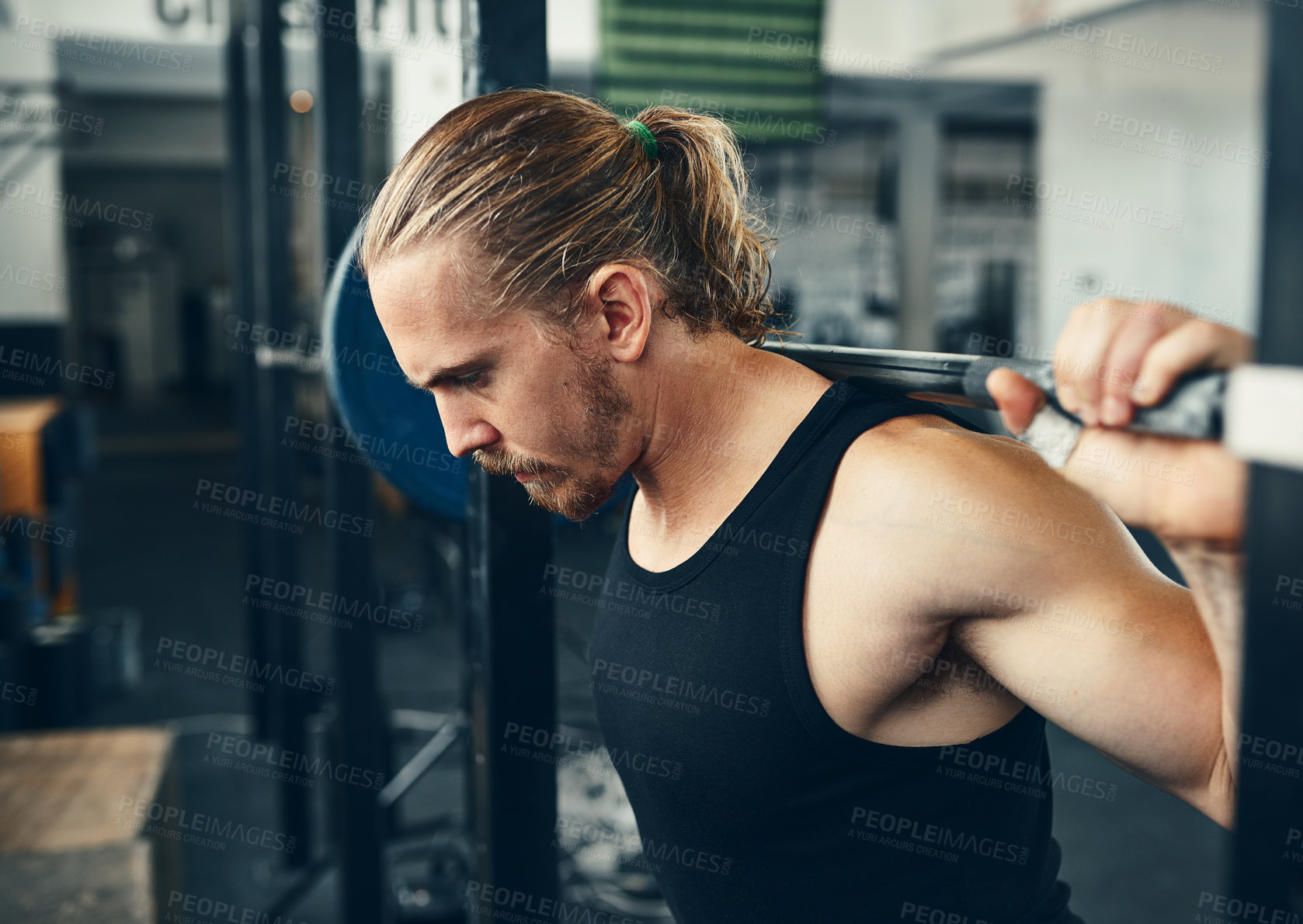 Buy stock photo Shot of a man lifting weights at the gym