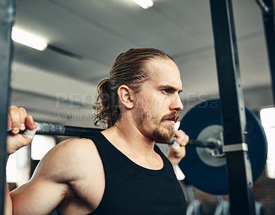 Buy stock photo Shot of a man lifting weights at the gym